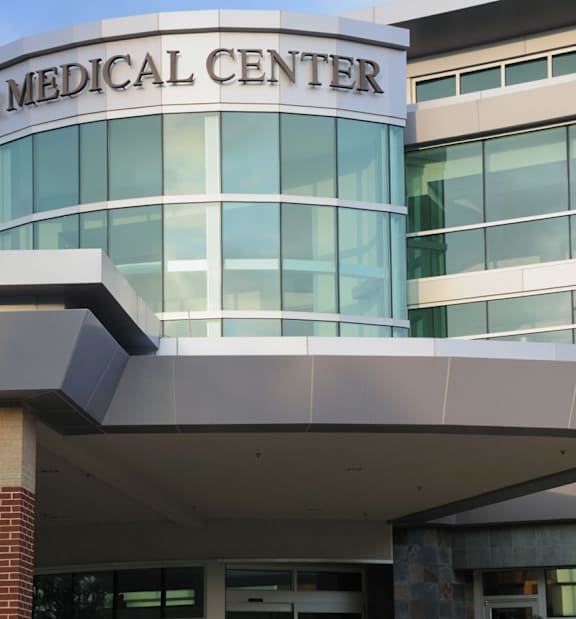 A building with a glass facade and a sign that says Medical Center.