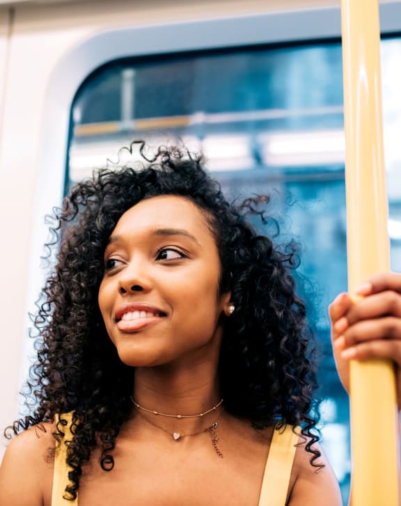 a woman riding a subway train holding on to a pole at Novella Biltmore, Phoenix, AZ 85016