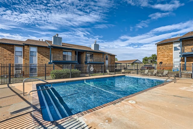 Apartment complex swimming pool and surrounding buildings.