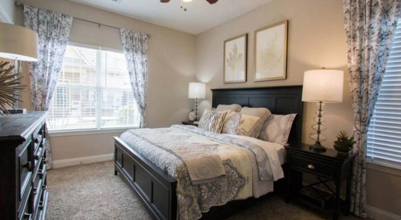 a bedroom with a bed and a fan
