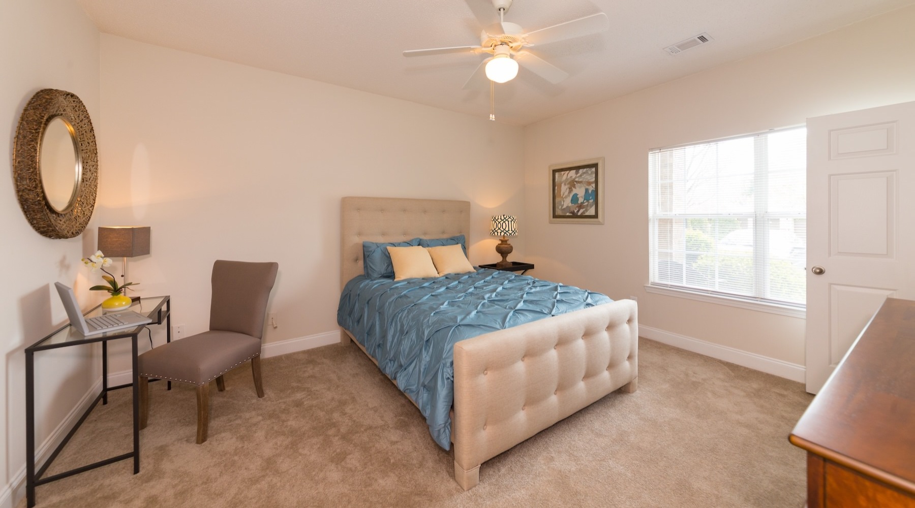 a bedroom with a bed, desk and chair