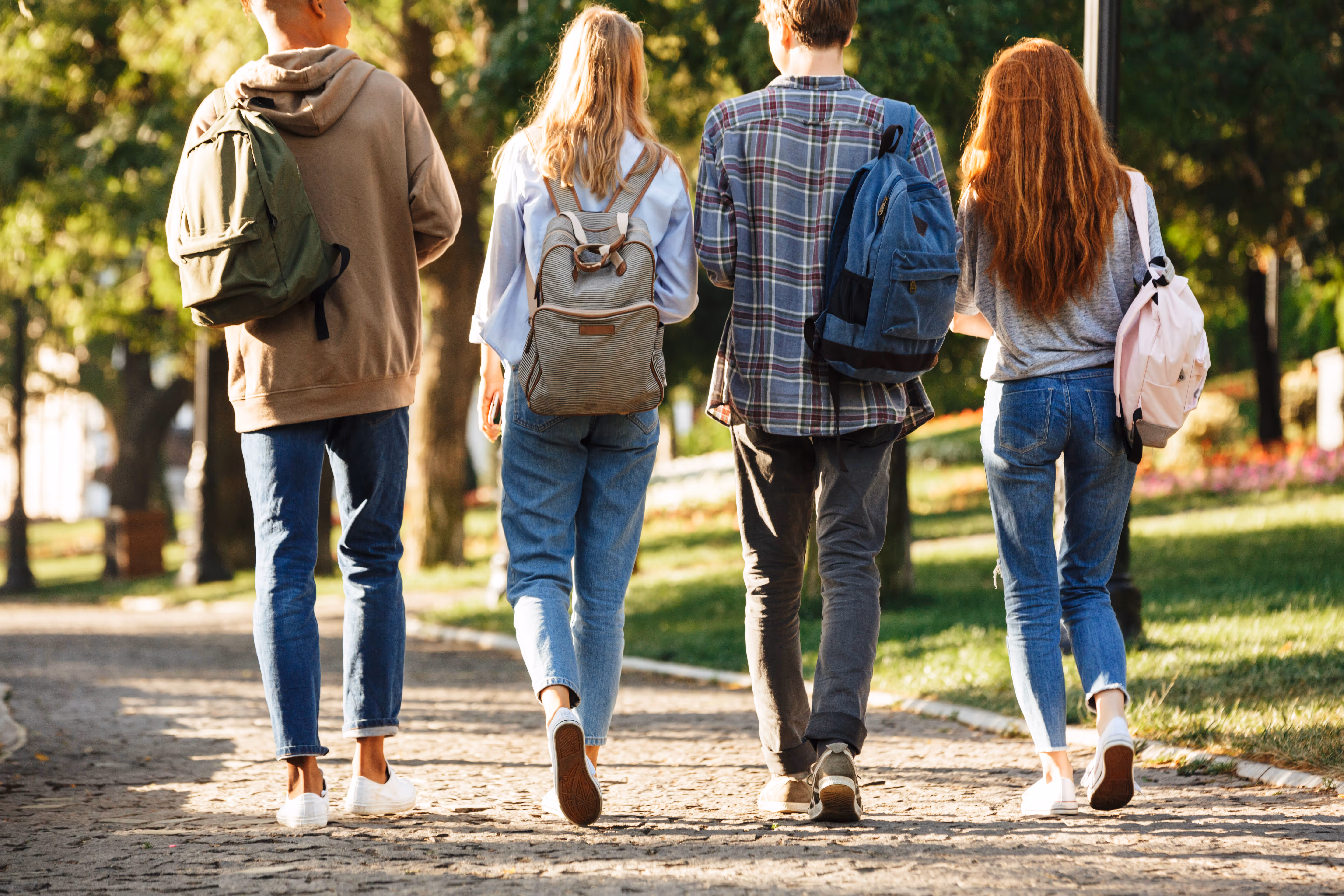 Students walking with book bags stock image