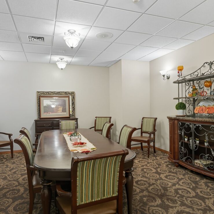 Elegant dining room with classic furnishings and warm fall décor fostering a welcoming community space.
