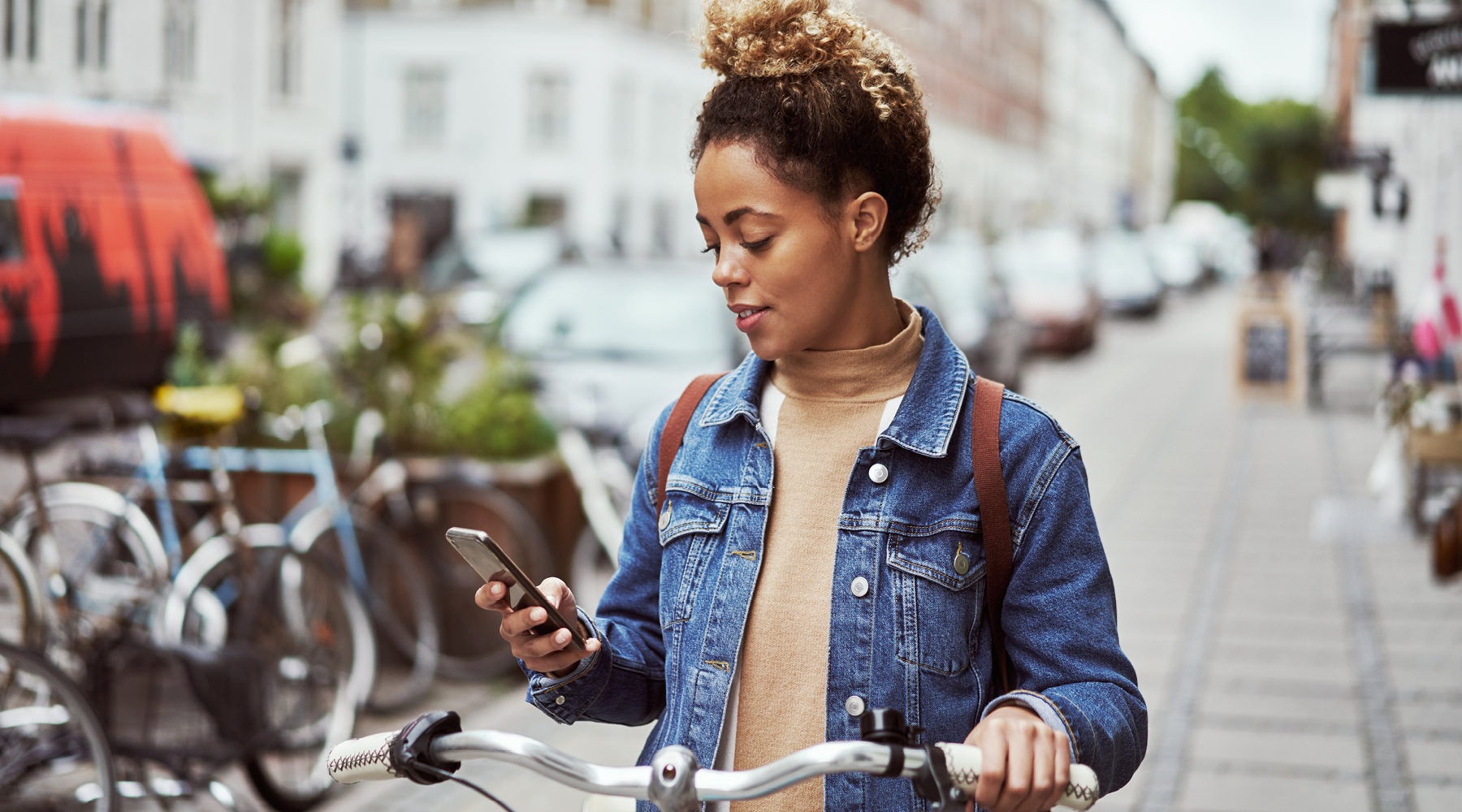 a woman on a bike looking at her cell