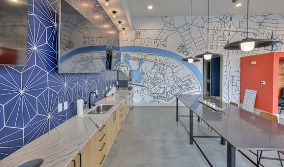 A kitchen with a blue wall and a map on the wall.