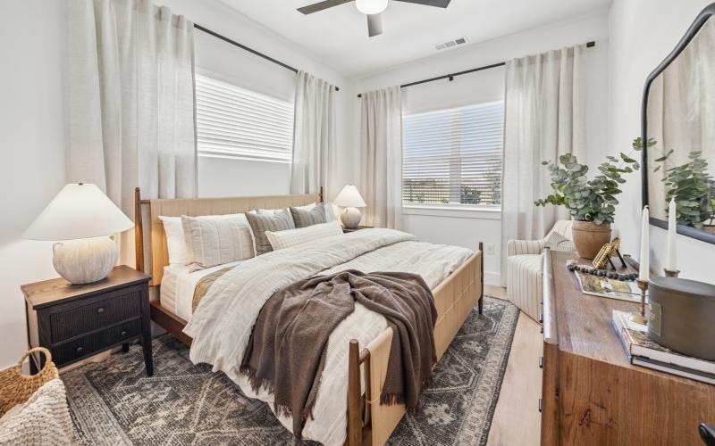 a bedroom with a bed and two nightstands