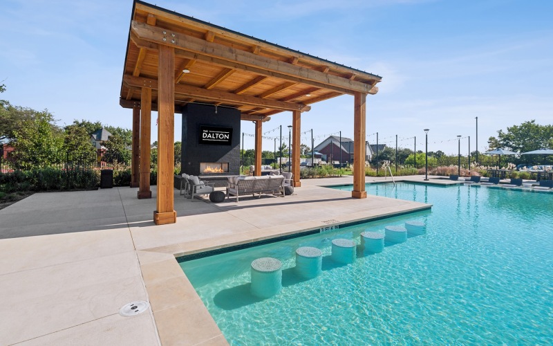 a swimming pool with an outdoor lounge area