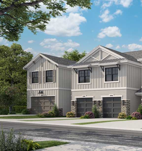 A row of houses with garages and driveways.