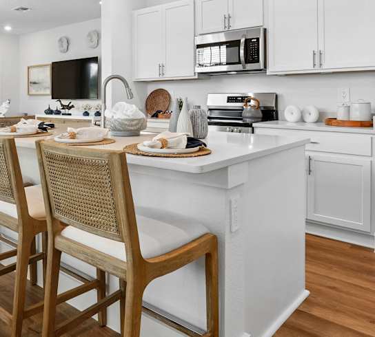A modern kitchen with a dining table and chairs.