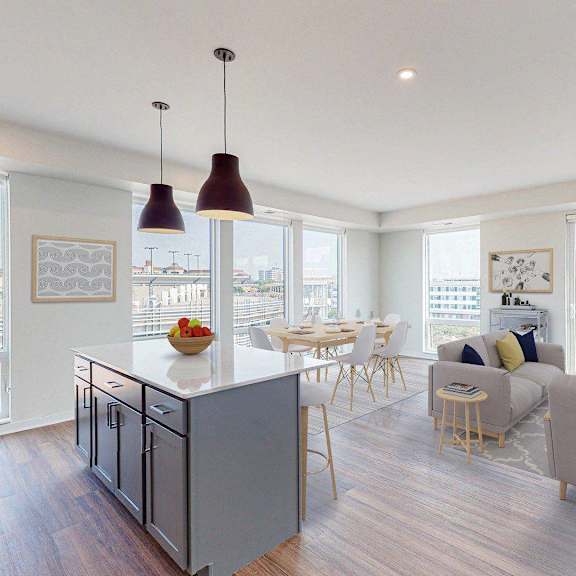 a kitchen and dining room with a table and chairs  at The Arlow on Kellog, Minnesota, 55102