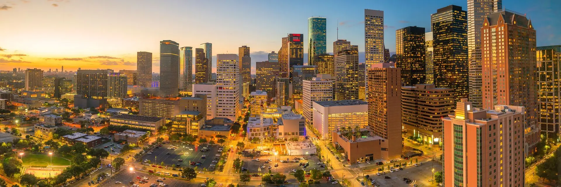 A stunning skyline view of a city at sunset, showcasing tall buildings and a vibrant atmosphere.