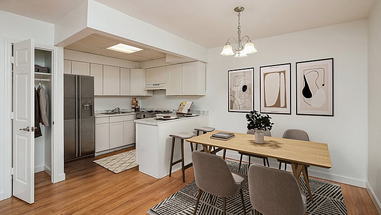 Chic open-plan kitchen and dining area with modern decor, sleek cabinetry, and stylish lighting.