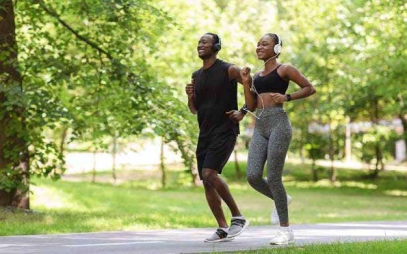 a man and woman running at Memorial Park in Houston