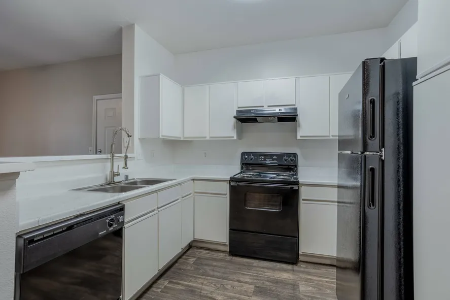 kitchen with black appliances and white cabinets