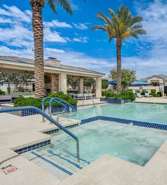 Resort style pool with spa and palm trees at Vistoria On Camelback Apartments, Litchfield Park, AZ