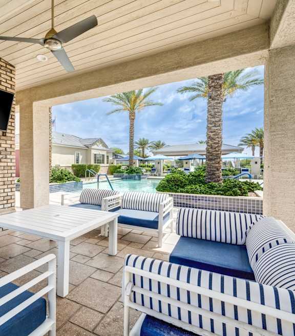 A patio with a white couch, a fireplace at Vistoria On Camelback Apartments, Arizona, 85340