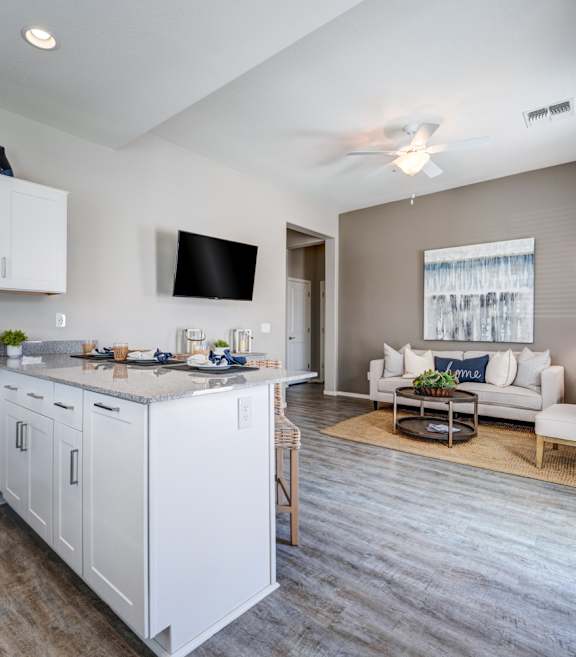 A modern kitchen with white cabinets and stainless steel appliances at Vistoria On Camelback Apartments, Arizona