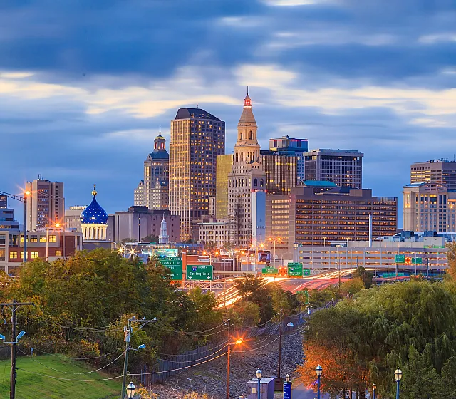 Stunning cityscape view showcasing a vibrant skyline with diverse architecture under a dramatic evening sky.