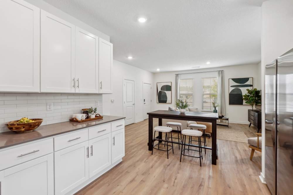 Wide view of large living room with eat-in kitchen at Hamlet at Wildlight in Yulee, Florida