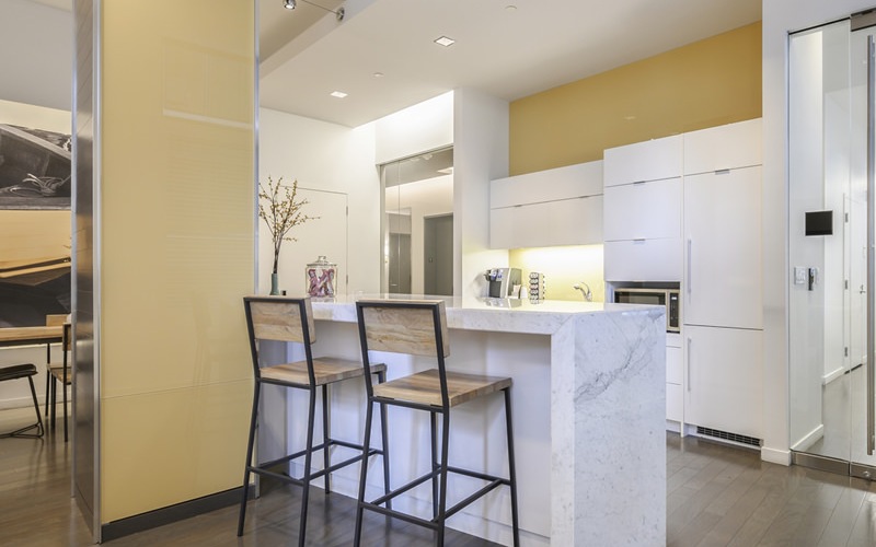 clubroom lounge with recessed lighting and stylized fixtures to brighten space	