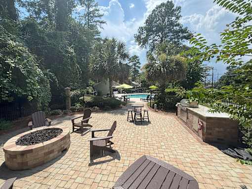 A backyard with a fire pit and patio furniture.