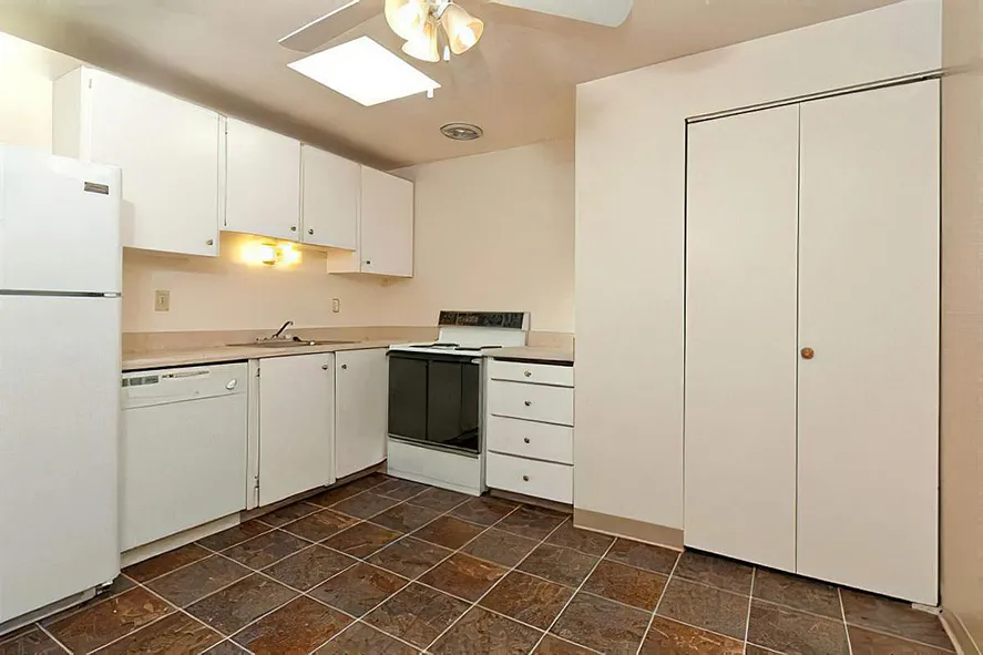 Black appliances in unit kitchen at Cottage Bay