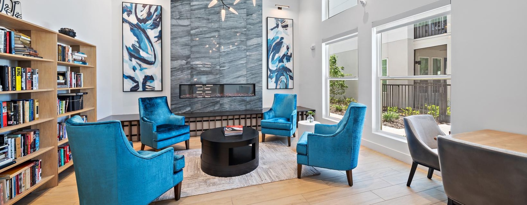 The resident lounge at Mira at Palmer Ranch apartments in Sarasota, FL, featuring wood grain floor paneling.