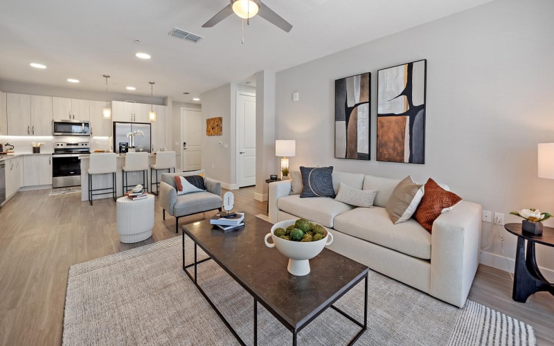a living room with a large ceiling fan a couch