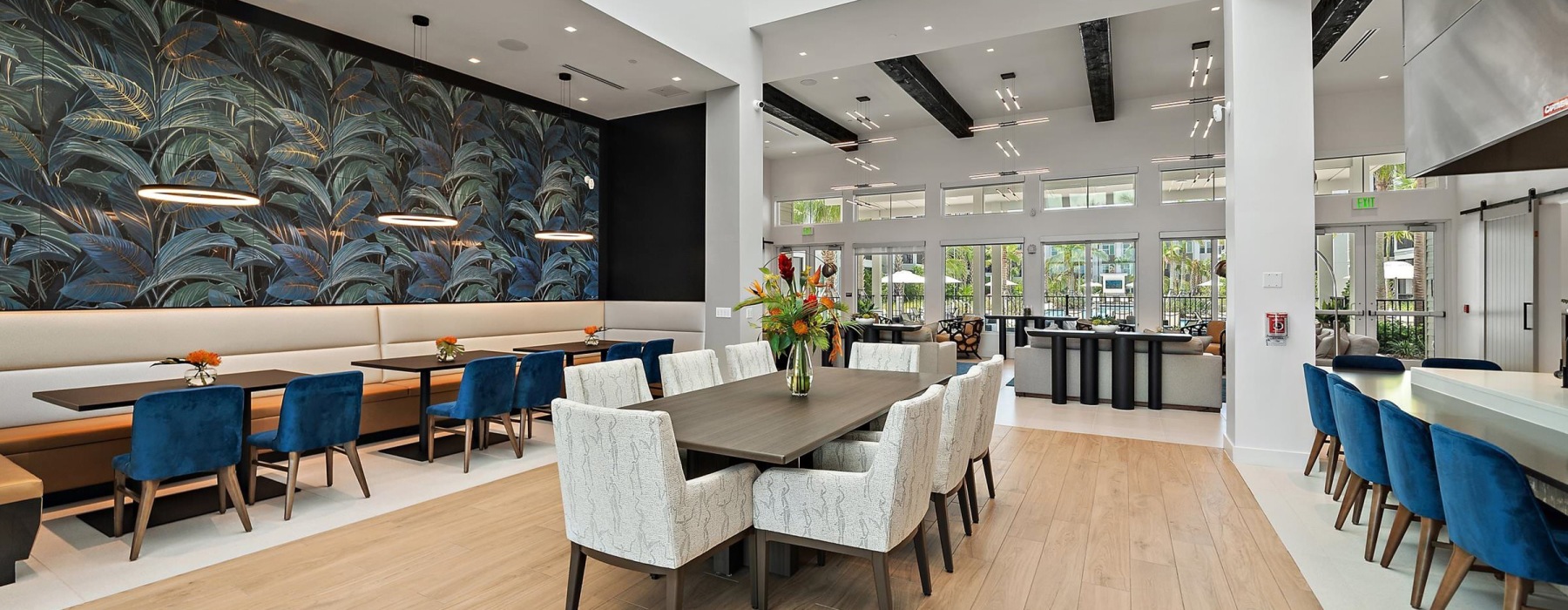 Resident lounge at Mira at Palmer Ranch apartments in Sarasota, FL, featuring wood grain flooring and ample seating.