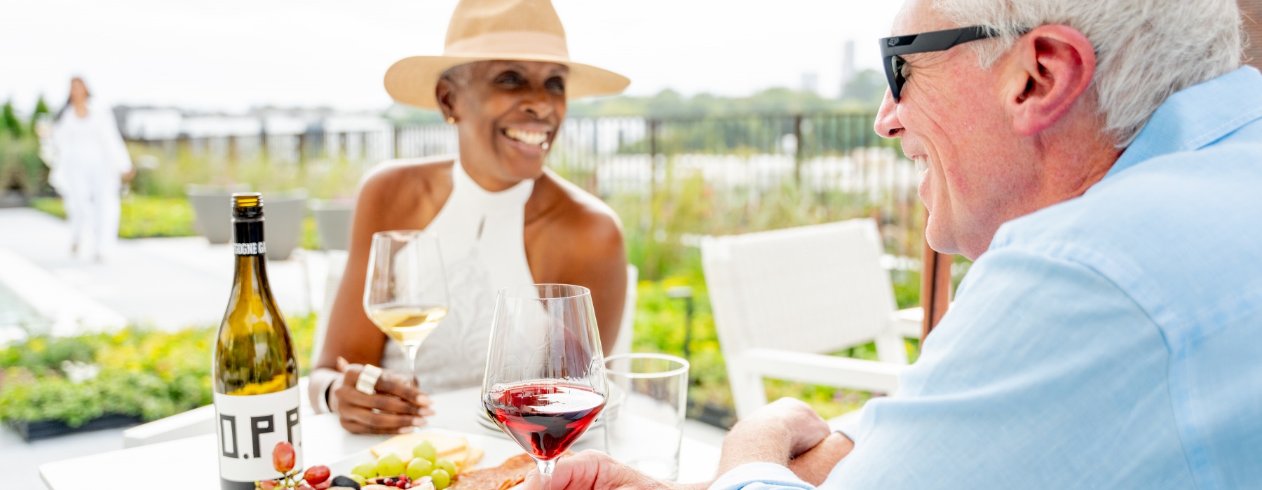 Signal House residents drinking wine and enjoying snacks on the rooftop terrace