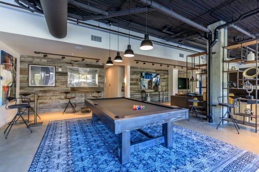 a pool table sits in the middle of a room with a bar in the background at Napoleon Apartments, Tacoma, 98402