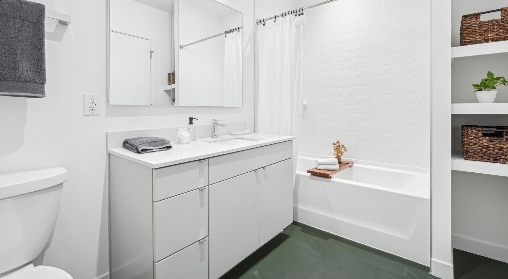 a bathroom with a tub sink and mirror