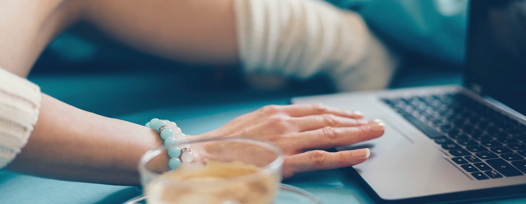 lifestyle image of a hand on her laptop