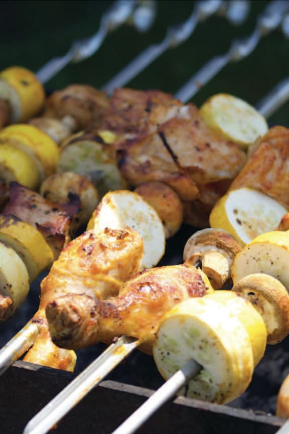 a close up of some skewers of food on a grill