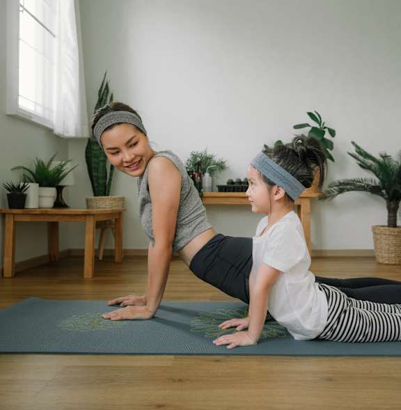 A Women with a Kid Doing Yoga at Estia Roseville Apartments, Roseville