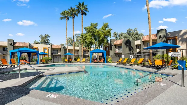 sparkling pool with shaded cabanas