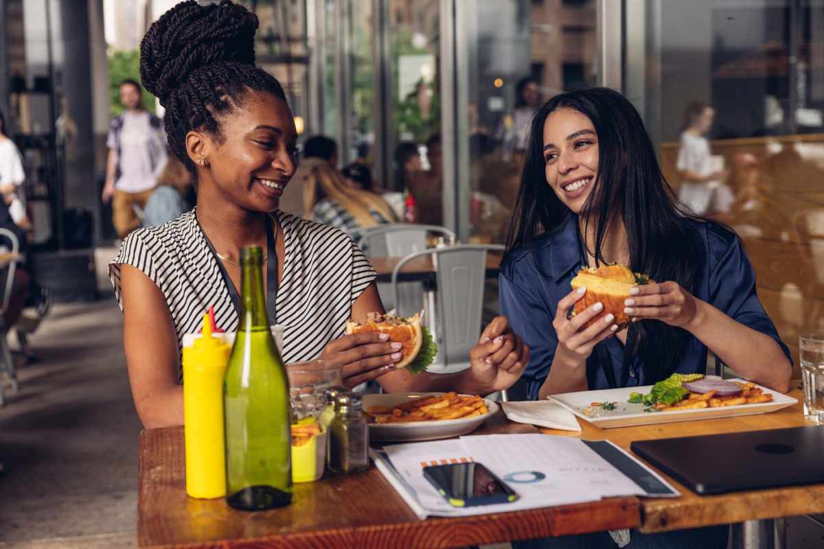 Two women enjoying burgers and fries at Overlook Terraces in Louisville, Kentucky 