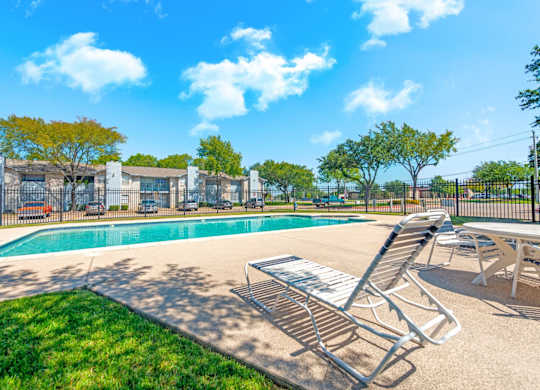 our apartments have a resort style pool with chairs and tables