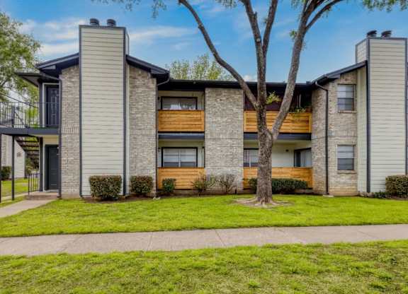 Two story apartment building with wood balconies at Marshall Apartments, Balch Springs, Texas
