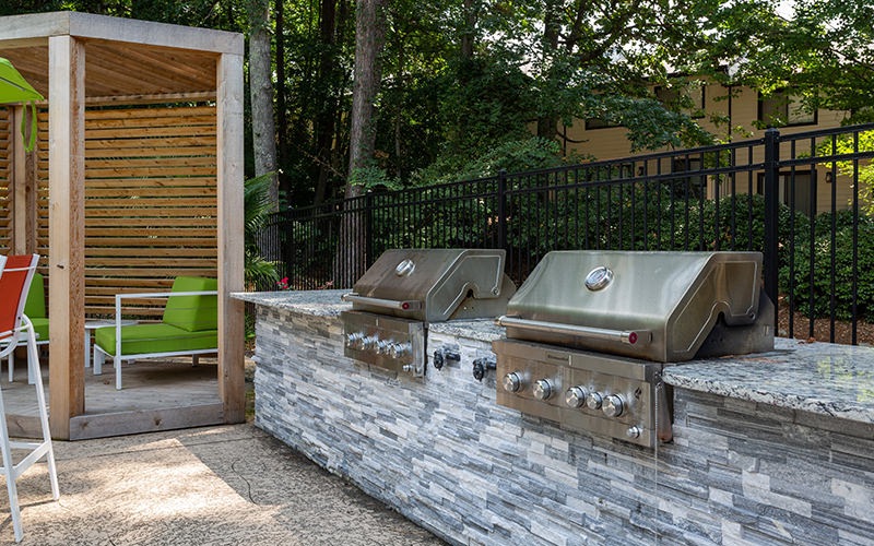 Large outdoor BBQ area with plenty covered seating adjacent to the pool 