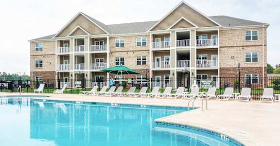 A large building with a pool in front.