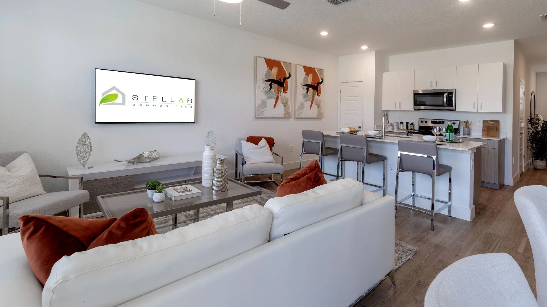 Modern living room and kitchen with sleek design and bright decor.