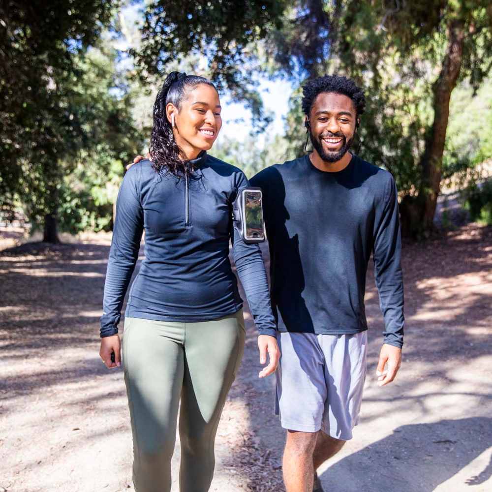 Resident couple walking in park at Casa Madrid in Cypress, California