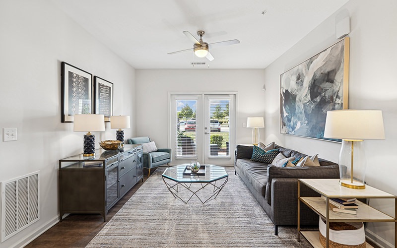 living room with a couch coffee table and windows