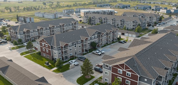 A large apartment complex with multiple buildings and parking lots.