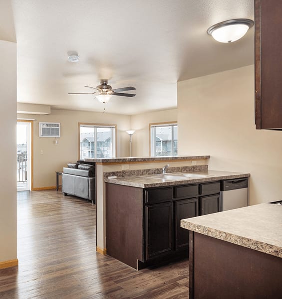 A kitchen with a counter and a fan.