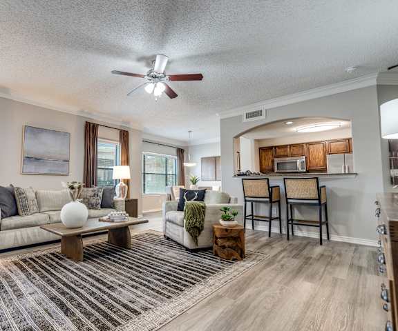 A living room with a couch, chairs, and a coffee table.