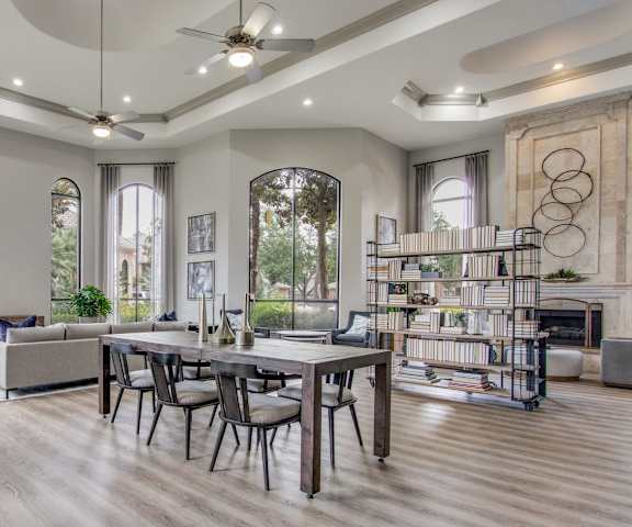 a living room with a table and chairs and a fireplace