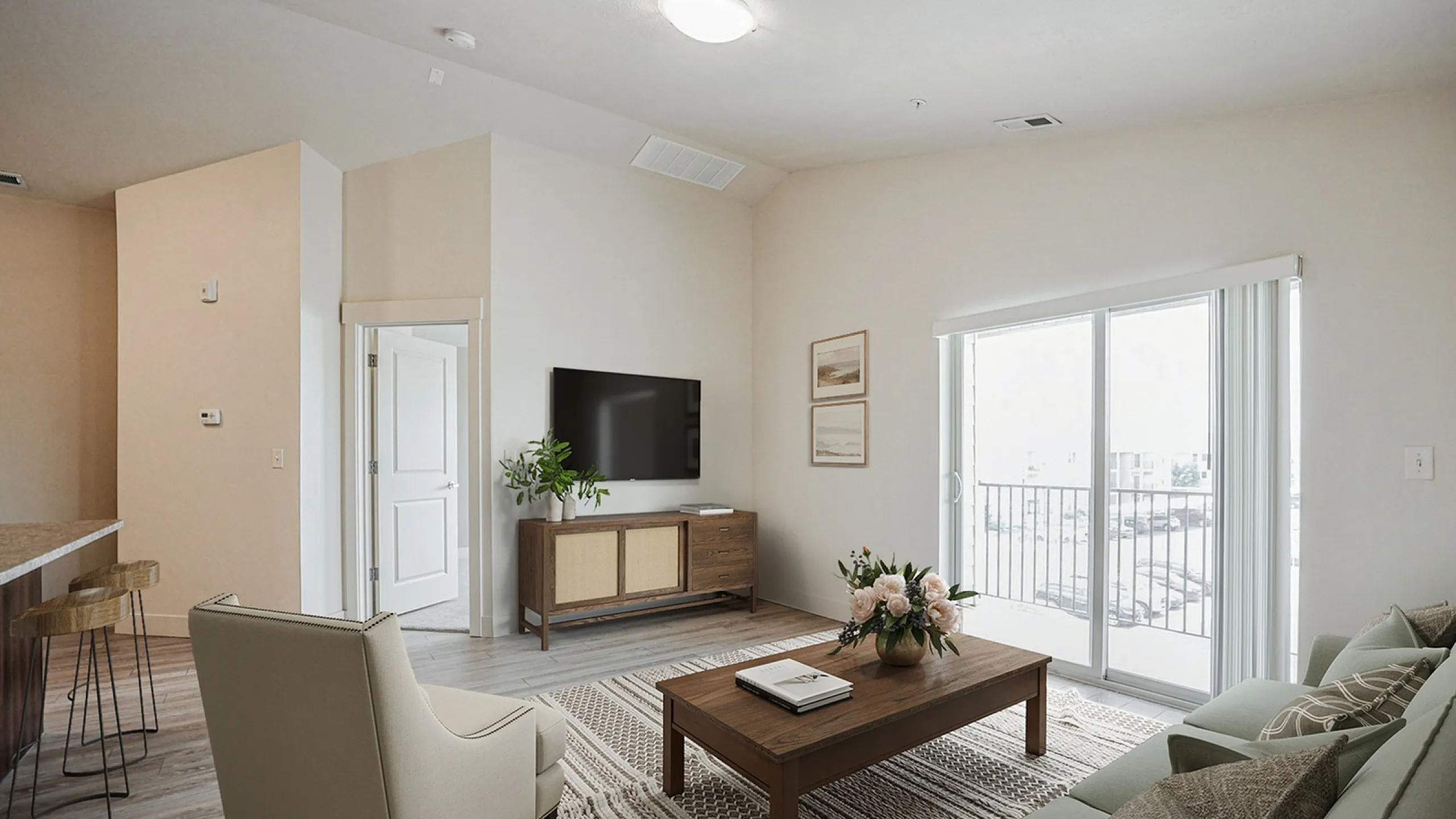 Bright and inviting living room with modern decor, cozy seating, and a large TV, leading to a sunny balcony through expansive sliding doors.