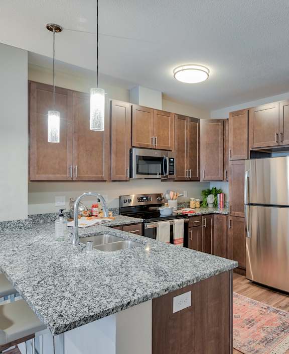 A modern kitchen with white cabinets and a central island.